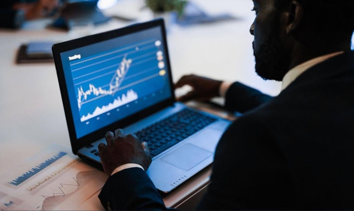Employee working on a business laptop with performance dashboards